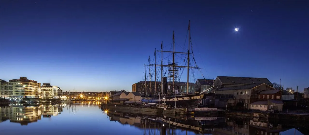 a boat docked in a harbor at night at The Bristol Hotel in Bristol