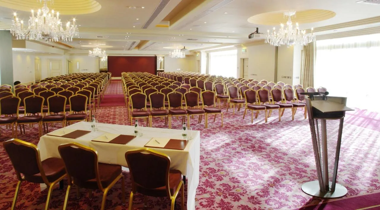 a large room with rows of chairs and a stage at The Bristol Hotel in Bristol