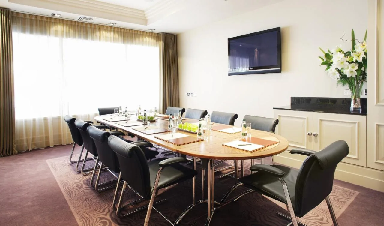 a conference room with a long table and chairs at The Bristol Hotel in Bristol